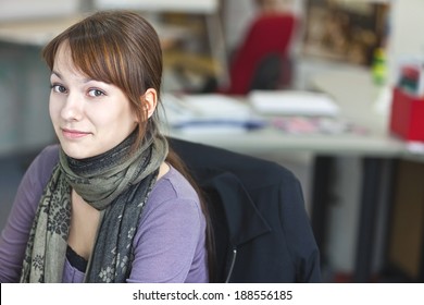 Real People - Portrait Of A Smart And Handsome Young Woman In Office With Available Light