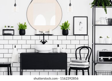 Real Photo Of Black And White Bathroom Interior With A Mirror, Cupboard, Chair And Plants