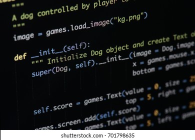 Real Python code developing screen. Programing workflow abstract algorithm concept. Lines of Python code visible under magnifying lens. - Shutterstock ID 701798635