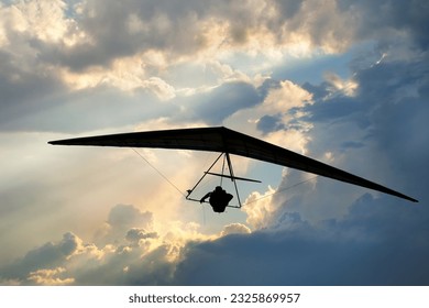 Real racing sport hang glider silhouette with dramatic sky on the background. 