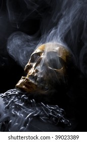 Real Skull With Chain In Abstract Smoke