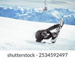 Real snowboarder falls at off piste ski slope. ski safety concept. Hand injury trauma fall on arms accident hard fall conceptual