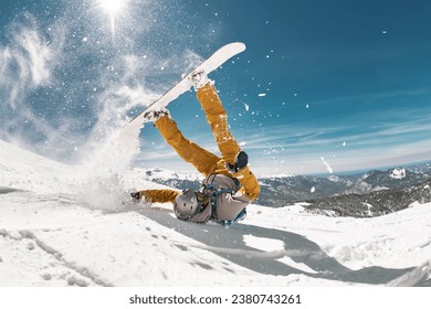 Real snowboarder falls at offpiste ski slope. ski safety concept