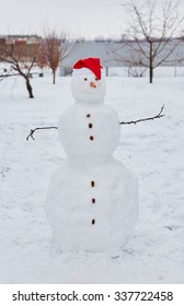 Real Snowman Outdoors In Winter White Scenery.