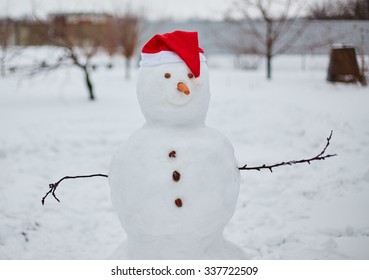 Real Snowman Outdoors In Winter White Scenery.