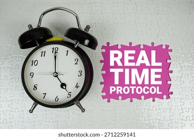 Real Time Protocol (RTP) text with alarm clock on pink background