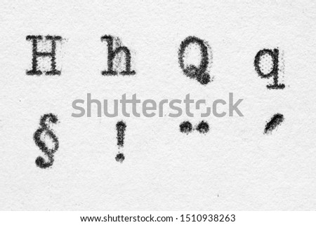 Real typewriter font alphabet with letters H, Q and paragraph, exclamation mark, dots above, acute accent symbols on white paper. Macro shot Stock foto © 
