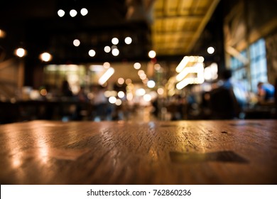 Real Wood Table  With Light Reflection On Scene At Restaurant, Pub Or Bar At Night. Blurred Background For Product Display Or Montage Your Products With Several Concept Idea And Any Occasion.