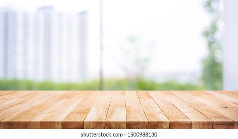 Real Wood Table Top Texture On Blur Leaf Tree Garden And Wall Building From City,park Background.For Create Product Display Or Design Key Visual Layout