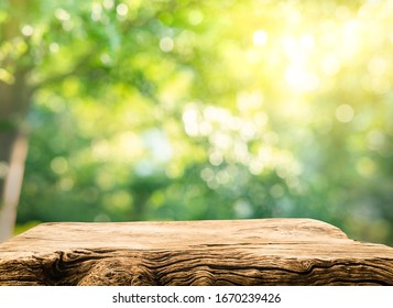 Real Wood Table Top Texture On Blur Leaf Tree Garden Background.For Create Product Display Or Design Key Visual Layout