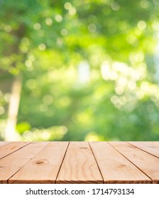 Real Wood Table Top Texture On Blur Leaf Tree Garden Background.For Create Product Display Or Design Key Visual Layout