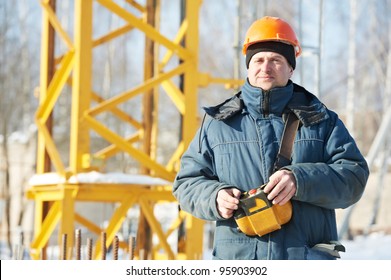 Real Worker Builder Operator With Tower Crane Remote Control Equipment At Construction Area Site