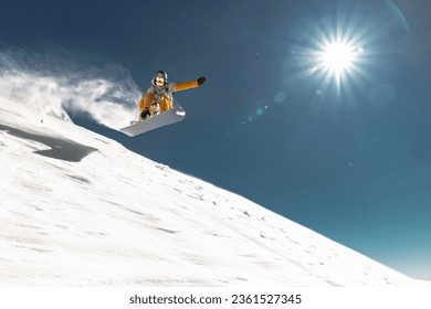 Real young snowboarder jumps and making trick from kicker at off piste ski slope. Winter vacations concept - Powered by Shutterstock