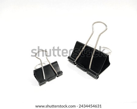 Realistic Black binder clip. Binder clip on white background. Realistic black paper clip on white background. Stationary concept