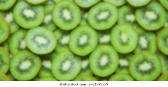 Realistic blurred kiwi slice pattern with overhead composition and organic texture. Food background ideal for commercial applications.