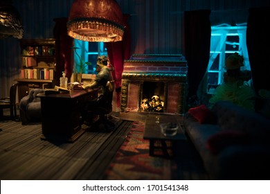 A Realistic Dollhouse Living Room With Furniture And Window At Night. Man Sitting On Table In Dark Room. Selective Focus.