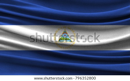 Realistic flag of Nicaragua on the wavy surface of fabric
