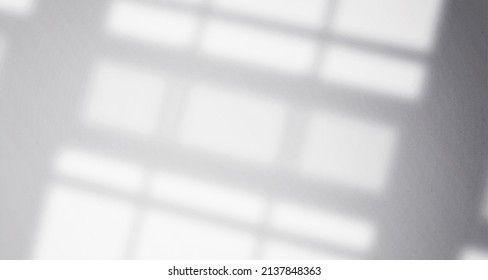 Realistic and minimalist blurred natural light windows, leaves shadow overlay on wall paper texture, abstract background, summer, spring, autumn for product presentation podium and mockup - Shutterstock ID 2137848363