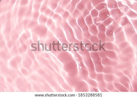 Realistic natural water wave overlay for background, blurred transparent pink colored water surface texture with splashes and bubbles, trendy abstract background