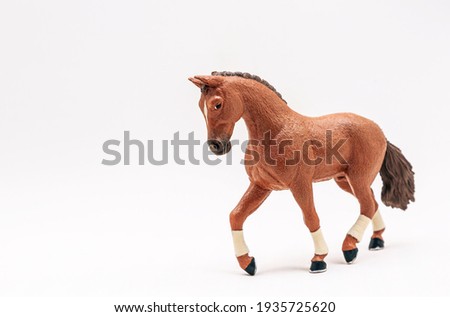 Realistic plastic toy horse, isolate on white background. Cute little horse toy for kids. Copy space