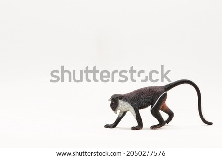Realistic plastic toy. A toy monkey. Cute little animal toy for kids