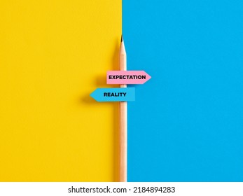 Reality vs expectation contrast or choice. Pencil with direction indicator stickers showing the distinction between expectations and reality.