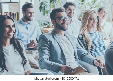 Really good info. Group of young people sitting on conference together and smiling - Powered by Shutterstock