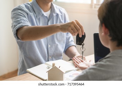 Realtor agent giving keys to tenant after sign agreement to rent property. - Shutterstock ID 717395464