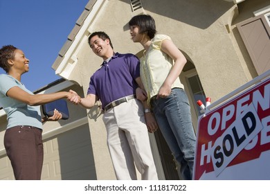 Realtor With Couple Buying New House