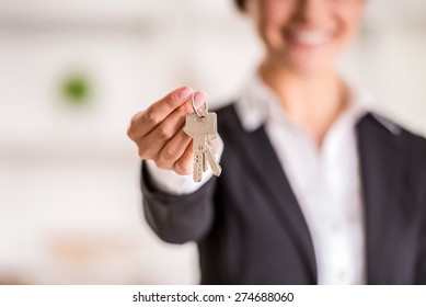 Realtor is giving the keys to an apartment to clients. Focus on the keys.
