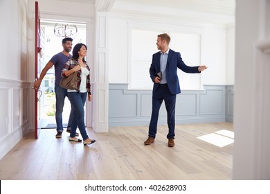 Realtor Showing Hispanic Couple Around New Home - Shutterstock ID 402628903