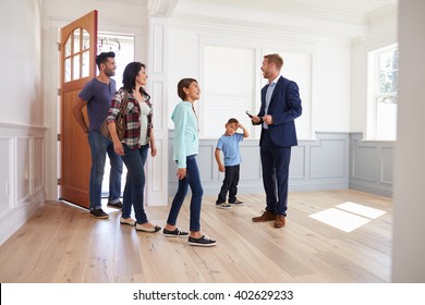 Realtor Showing Hispanic Family Around New Home - Shutterstock ID 402629233