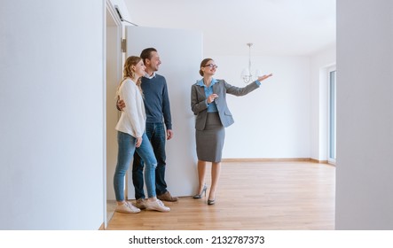 Realtor showing house to a young couple - Shutterstock ID 2132787373