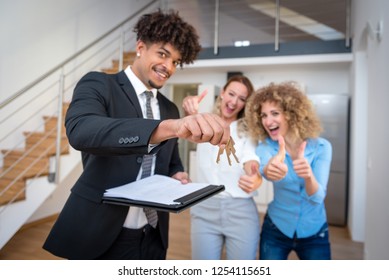 Realtor Showing Keys To New Apartment Giving The Client A Tour