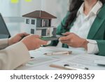 Realtor talking with a customer about loan from bank for buy new house apartment in modern office. The concept of financial home loan or money-saving for house buying, real estate, and insurance.