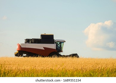 Reaping Machine. Combine Harvester In The Field During The Harvest. Side View.