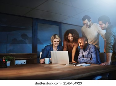 Reaping The Rewards Of Hard Work. Shot Of A Team Of Young Businesspeople Working Late In The Office.