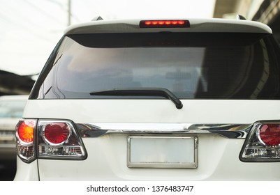 Rear aspect or back blank plate 
view of SUV car in day time real road