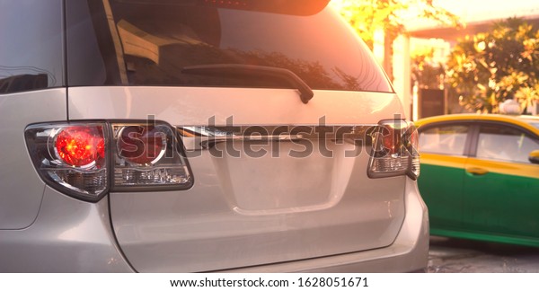 Rear aspect of car or hatchback mock up plate\
with sun flare on traffic\
background