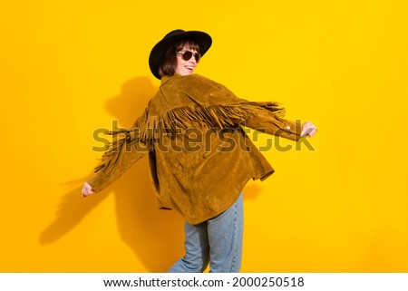 Rear back behind view portrait of attractive cheery girl dancing having fun isolated over bright yellow color background