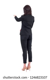 Rear Back View Of Business Woman In Suit Interacting With Touch Screen Or Pointing Finger At Presentation. Full Body Isolated On White Background. 