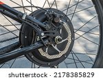 Rear bicycle motor wheel integrated into mountain bike close-up from side of the brake disc