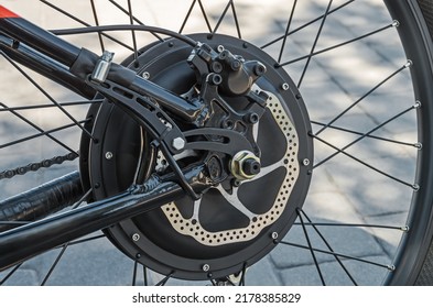 Rear bicycle motor wheel integrated into mountain bike close-up from side of the brake disc