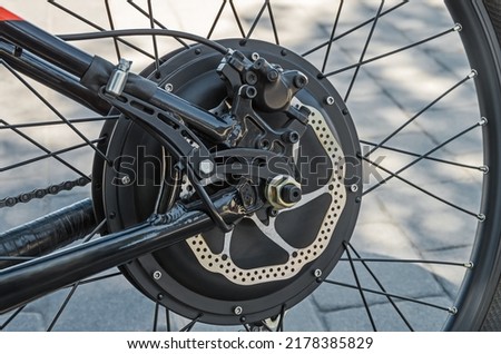 Rear bicycle motor wheel integrated into mountain bike close-up from side of the brake disc