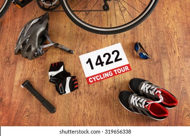 Rear bicycle wheel and other accessories on the wooden floor