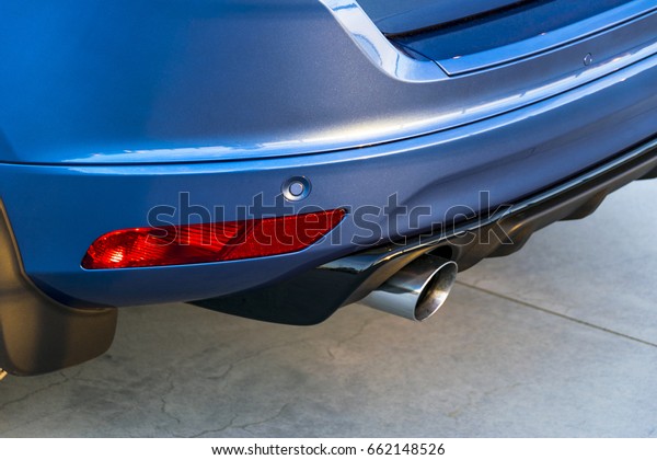 Rear bumper of a car with exhaust pipe, modern\
car exterior details