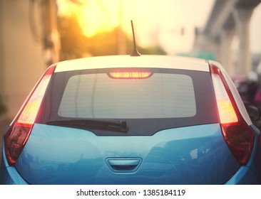 rear car aspect with sun light on blur city background