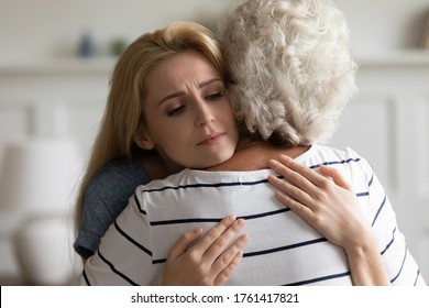 Rear Close Up View Aged Grey-haired Mother Cuddles Her Grown Up Daughter. Teen Granddaughter Strong Embrace Loving Grandma Feeling Empathy Worried About Older Relative Woman Health, Share Mental Pain