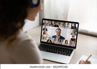 Rear close up view of female employee have webcam digital virtual conference or meeting on laptop with diverse colleagues. Woman talk speak on video call on computer, engaged in online briefing. - Shutterstock ID 1822495160