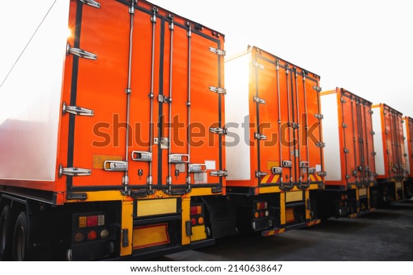 Rear of Containers Trailer Trucks Parking\
Lot. Safety Locked  Shipping Container Door. Lorry. Industry\
Freight Trucks Logistics Cargo\
Transport.	